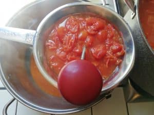 Tomato puree in a narrow mesh vegetable mill